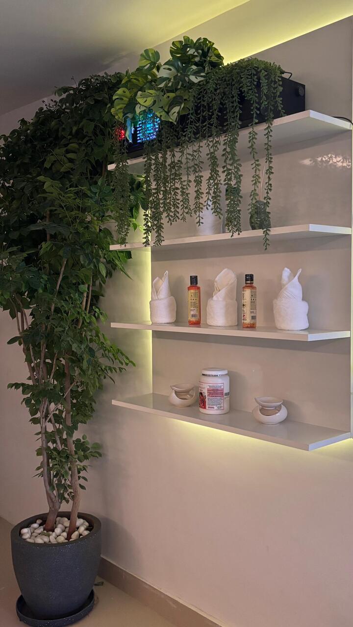 Inside the entrance: living plants trailing over lit shelves, the LED glow beneath each one